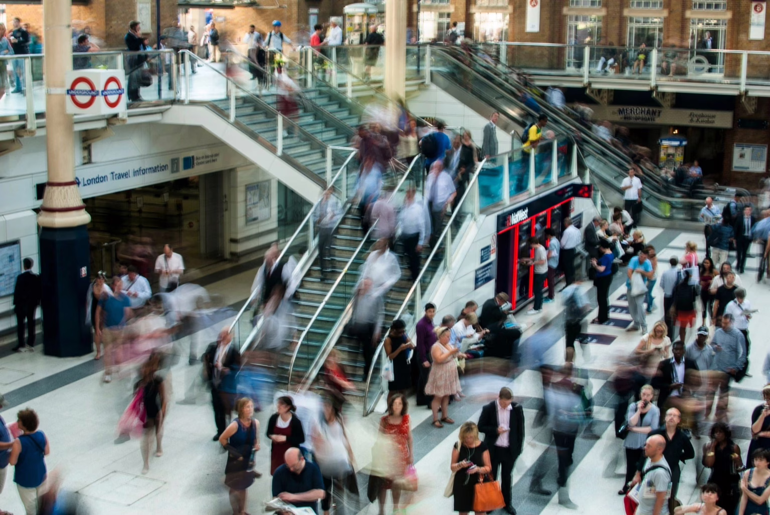 Crowd of people moving through a busy station