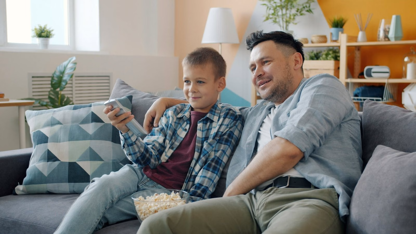 Father and son watching streaming TV on the couch